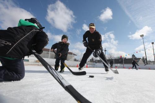 Roblin Park Community Club ice maker Marcy Beaucage, broke the record for the latest ever outdoor hockey rink in his lifetime of ice making Saturday when he iced the rink the night before and told members to come out for a game of "Shinny" Saturday.  Marcy plays a little hockey with his grandson Kiedis Chudyk Saturday morning. Photography Ruth Bonneville Ruth Bonneville /  Winnipeg Free Press)