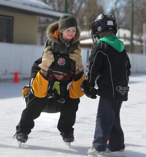 Roblin Park Community Club ice maker Marcy Beaucage, broke the record for the latest ever outdoor hockey rink in his lifetime of ice making Saturday when he iced the rink the night before and told members to come out for a game of "Shinny" Saturday.  Lee Beaucage  carries his  nephew Kiedis Chudyk on the ice Saturday morning. Photography Ruth Bonneville Ruth Bonneville /  Winnipeg Free Press)