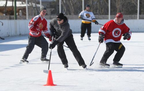 Roblin Park Community Club ice maker Marcy Beaucage, broke the record for the latest ever outdoor hockey rink in his lifetime of ice making Saturday when he iced the rink the night before and told members to come out for a game of "Shinny" Saturday. Members of the community play a pick up game of hockey Saturday morning. Photography Ruth Bonneville Ruth Bonneville /  Winnipeg Free Press)