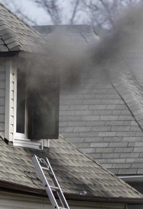 Smoke pours out of a second floor window at a house fire on Union Street, Saturday, April 13, 2013. (TREVOR HAGAN/WINNIPEG FREE PRESS)