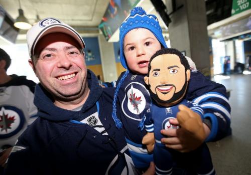 David Lubkiwski and his son, Isaac 2, holding a Dustin Byfuglien plush toy, during the Winnipeg Jets' special practice that was open to fans on the ticket waiting list at MTS Centre in Winnipeg, Sunday, April 14, 2013. (TREVOR HAGAN/WINNIPEG FREE PRESS)