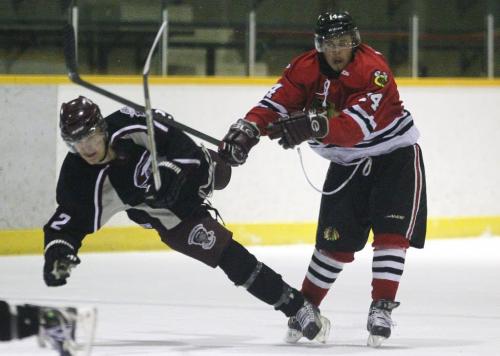 April 14, 2013 - 130414  -  Charleswood Hawk Doug Lawrence (14)(R) checks Pembina Valley Twister Kevin Coulombe (12) in game three of the MMJHL final series at Eric Coy Arena Sunday, April 14, 2013. John Woods / Winnipeg Free Press