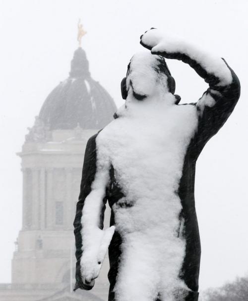 The airman in training memorial statue on Memorial Blvd in front of the Manitoba Legislature is bombarded by snow from the north during a Alberta Clipper that hit Winnipeg and Southern Manitoba MondayStandup photo- April 15, 2013   (JOE BRYKSA / WINNIPEG FREE PRESS)