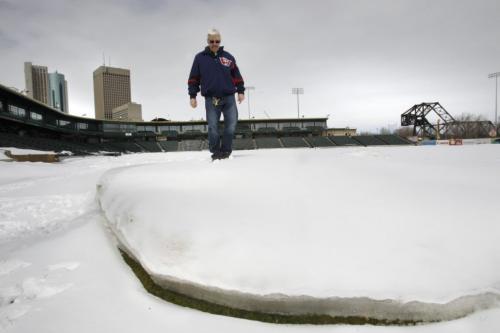 Sports. Don Ferguson, Facility and Grounds Manager stands on a snow drift at the edge of right field in Shaw Park Tuesday. Melissa Martin story on how snow impacts the Goldeyes at Shaw Park (WAYNE GLOWACKI/WINNIPEG FREE PRESS) Winnipeg Free Press April 16 2013