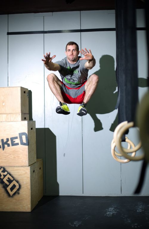 Brandon Sun 17042013 Zach McMillan does a high leap for a photo after training at Crossfit Rocked on 10th Street in Brandon on Tuesday. (Tim Smith/Brandon Sun)