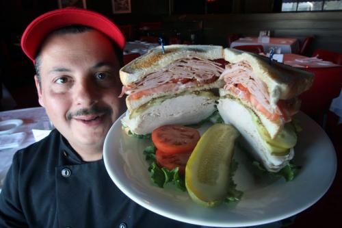 Chef Bill Georgakopoulos shows off the massive clubhouse sandwich at Rae and JerrysSee Marion Warhaft review- April 18, 2013   (JOE BRYKSA / WINNIPEG FREE PRESS)
