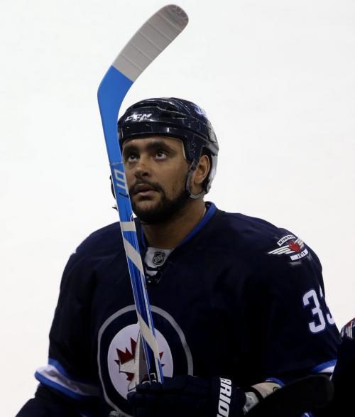 Winnipeg Jets' Dustin Byfuglien (33) examines a new stick during first period NHL action against the New York Islanders' at MTS Centre in Winnipeg, Saturday, April 20, 2013. (TREVOR HAGAN/WINNIPEG FREE PRESS)