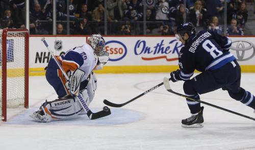 New York Islanders' goaltender Evgeni Nabokov stops Winnipeg Jets' Alexander Burmistrov (8) on a breakaway during second period NHL action at MTS Centre in Winnipeg, Saturday, April 20, 2013. (TREVOR HAGAN/WINNIPEG FREE PRESS)