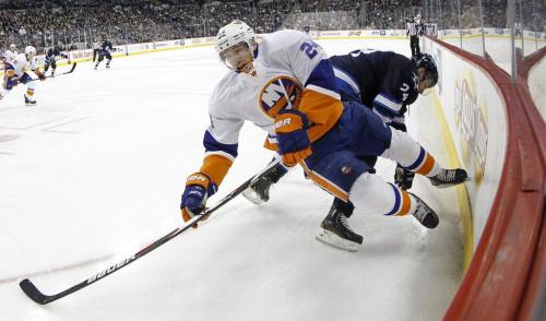 New York Islanders' Brad Boyes (24) is checked by Winnipeg Jets' Grant Clitsome (24) during second period NHL action at MTS Centre in Winnipeg, Saturday, April 20, 2013. (TREVOR HAGAN/WINNIPEG FREE PRESS)