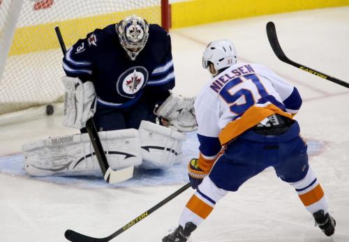 New York Islanders' Frans Nielsen (51) puts the puck past Winnipeg Jets' goaltender Ondrej Pavelec (31) to open the scoring during first period NHL action at MTS Centre in Winnipeg, Saturday, April 20, 2013. (TREVOR HAGAN/WINNIPEG FREE PRESS)