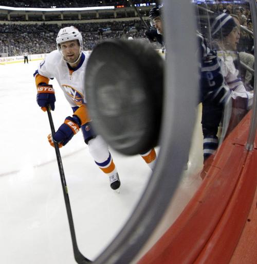 New York Islanders' Lubomir Visnovsky (11) looks on as the puck nearly pokes through the photographers hole during second period action against the Winnipeg Jets' at MTS Centre in Winnipeg, Saturday, April 20, 2013. (TREVOR HAGAN/WINNIPEG FREE PRESS)