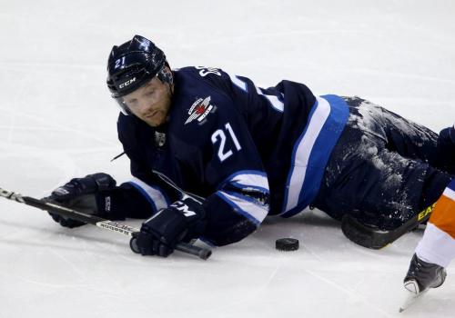 Winnipeg Jets' Aaron Gagnon (21) falls near the puck during third period NHL action against the New York Islanders' at MTS Centre in Winnipeg, Saturday, April 20, 2013. (TREVOR HAGAN/WINNIPEG FREE PRESS)