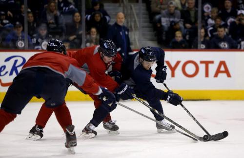 Winnipeg Jets' Arturs Kulda (23) Jacob Trouba (3) and Aaron Gagnon (21) battle for the puck during practice at MTS Centre in front of about 3000 fans from the ticket waiting list who were invited to the special event, Sunday, April 14, 2013. (TREVOR HAGAN/WINNIPEG FREE PRESS)
