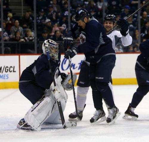 Winnipeg Jets' Olli Jokinen (12) and Mark Stuart (5) battle for position in front of goaltender Ondrej Pavelec (31) during practice at MTS Centre in front of about 3000 fans from the ticket waiting list who were invited to the special event, Sunday, April 14, 2013. (TREVOR HAGAN/WINNIPEG FREE PRESS)