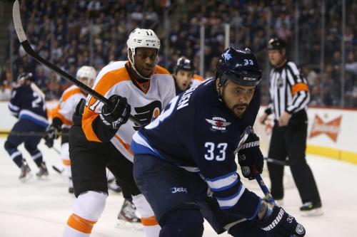 Winnipeg Jets' Dustin Byfuglien (33) is chased into the corner by Philadelphia Flyers' Wayne Simmonds (17) during the second period NHL hockey action, Saturday, April 6, 2013. (TREVOR HAGAN/WINNIPEG FREE PRESS)