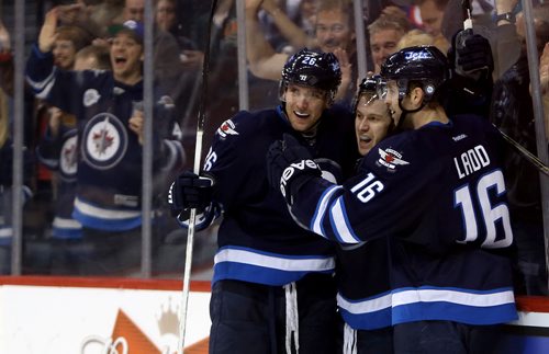 Winnipeg Jets' Blake Wheeler (26), Bryan Little (18) and Andrew Ladd (16) celebrate after Little scored during second period NHL hockey action against the Philadelphia Flyers at MTS Centre in Winnipeg, Saturday, April 6, 2013. (TREVOR HAGAN/WINNIPEG FREE PRESS)