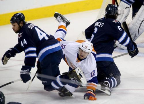 Winnipeg Jets' Zach Bogosian (44) and Ron Hainsey (6) combine on a hit against New York Islanders' Josh Bailey (12) to the right of goaltender Ondrej Pavelec (31) during first period NHL action at MTS Centre in Winnipeg, Saturday, April 20, 2013. (TREVOR HAGAN/WINNIPEG FREE PRESS)