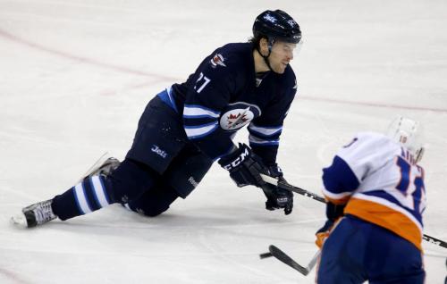 Winnipeg Jets' Eric Tangradi (27) lays down to makes one of four blocks in a single shift, this one against New York Islanders' Keith Aucoin (10), during third period NHL action at MTS Centre in Winnipeg, Saturday, April 20, 2013. (TREVOR HAGAN/WINNIPEG FREE PRESS)