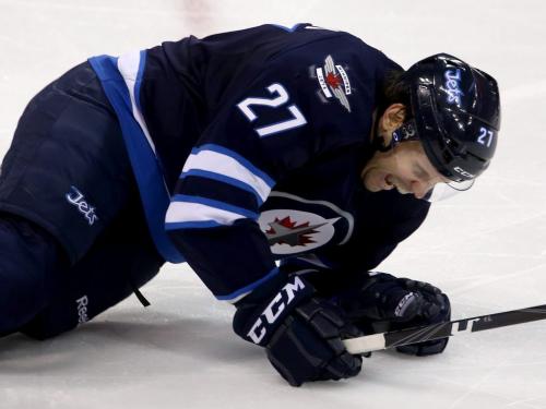 Winnipeg Jets' Eric Tangradi (27) in pain after making one of four blocks in a single shift during third period NHL action against the New York Islanders' at MTS Centre in Winnipeg, Saturday, April 20, 2013. (TREVOR HAGAN/WINNIPEG FREE PRESS)
