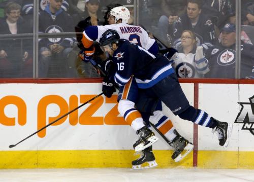 New York Islanders' Travis Hamonic (3) is hit hard into the boards by Winnipeg Jets' Andrew Ladd (16) during third period play MTS Centre in Winnipeg, Saturday, April 20, 2013. (TREVOR HAGAN/WINNIPEG FREE PRESS)
