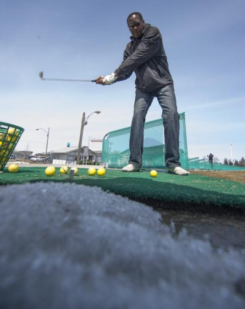 130420 Winnipeg - DAVID LIPNOWSKI / WINNIPEG FREE PRESS  Archie Edmonds hits some balls at the driving range at Shooters Family Golf Centre Saturday morning. Shooters opening the driving range for the first time this year today. (He is retrieving his swing meter as it had fallen off his club.)