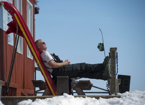 130420 Winnipeg - DAVID LIPNOWSKI / WINNIPEG FREE PRESS  Volunteer ski patrol member Robert Paige enjoys a break in the sun at Stony Mountain Ski Area, which was still open Saturday afternoon, with dozens of skiers and snowboarders having a great time in the sun.