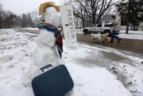 A snowman with his bag packed and a sign that reads "Mexico or bust" on Egerton Road in St.Vital, Sunday, April 20, 2013. (TREVOR HAGAN/WINNIPEG FREE PRESS)