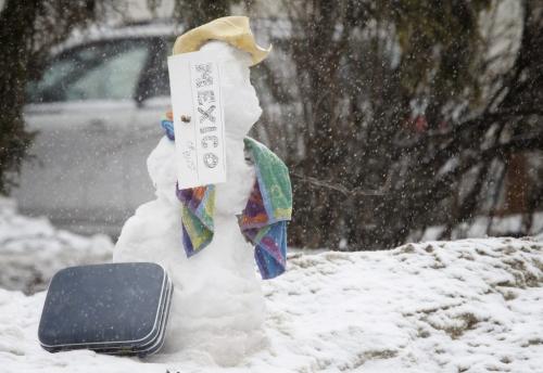 A snowman with his bag packed and a sign that reads "Mexico or bust" on Egerton Road in St.Vital, Sunday, April 20, 2013. (TREVOR HAGAN/WINNIPEG FREE PRESS)