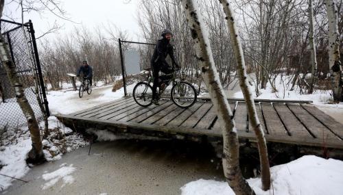 Cyclists cross a bridge during FortWhyte AliveÄôs EcoAdventure Race. The race is a multi-sport adventure race that includes paddling, running, orienteering and cycling over a 35K course through FortWhyte Alive and Assiniboine Park. Sunday, April 21, 2013. (TREVOR HAGAN/WINNIPEG FREE PRESS)