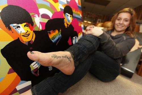 April 22, 2013 - 130422  -  Victoria Ploszay shows off her Beatles tattoo with some of their Beatles paraphernalia in her home Monday, April 22, 2013. John Woods / Winnipeg Free Press