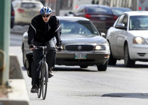 Cyclist on Main St. in downtown Winnipeg Tuesday. Bruce Owen story(WAYNE GLOWACKI/WINNIPEG FREE PRESS) Winnipeg Free Press April 23 2013