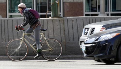 Cyclist on Main St. in downtown Winnipeg Tuesday. Bruce Owen story(WAYNE GLOWACKI/WINNIPEG FREE PRESS) Winnipeg Free Press April 23 2013