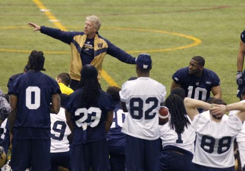 Head Coach Tim Burke with players at the end of the first day of the Winnipeg Blue Bombers  three day mini-camp held in the Winnipeg Indoor Soccer Complex  Wednesday.  Paul Wiecek  story(WAYNE GLOWACKI/WINNIPEG FREE PRESS) Winnipeg Free Press April 24 2013