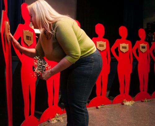 Debbie Scromeda touches the plaque bearing her daughter's name on a silhouette as part of the 2013 Silent Witness Memorial Project. Scromeda's daughter Shannon was murdered in 2008 by her partner. The Family Violence Consortium of Manitoba held the memorial to remember victims of domestic violence on Wednesday at the West End Cultural Centre. 130424 - Wednesday, April 24, 2013 - (Melissa Tait / Winnipeg Free Press)