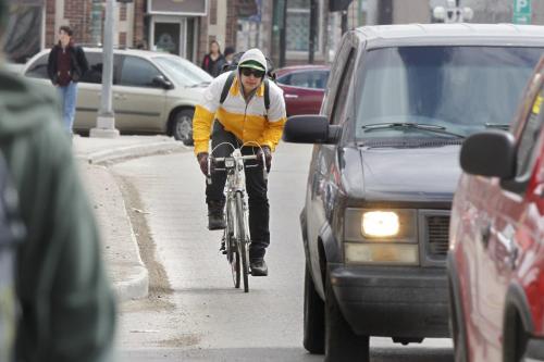 Cyclist travels through the Osborne Village on Osborne St. Wednesday.  Bruce Owen story(WAYNE GLOWACKI/WINNIPEG FREE PRESS) Winnipeg Free Press April 24 2013