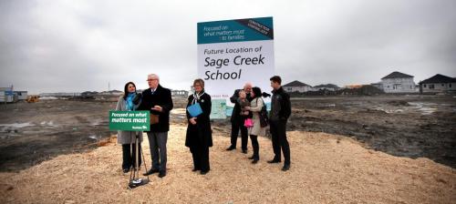 Premier Greg Selinger ad others share a muddy podium to announce the start of Sage Creek School. See Larry Kusch story. April 24, 2013 - (Phil Hossack / Winnipeg Free Press)