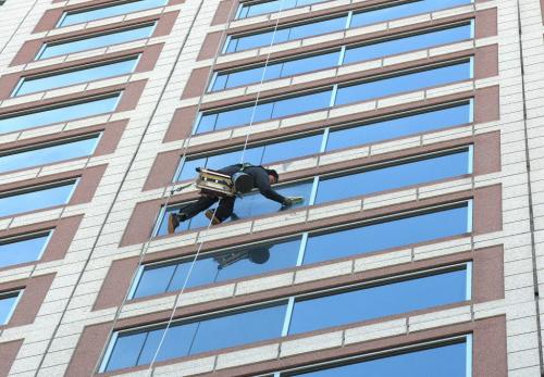 Spring Cleaning-A window washer works on the big job at the 33 story building at Portage And Main called 201 Portage-Standup Photo- April 25, 2012   (JOE BRYKSA / WINNIPEG FREE PRESS)