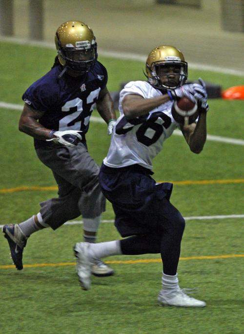 Stdup - Blue Bomber mini camp at #86 WR ,  Isaac Anderson makes catch with DB #23 Jonathan Hefney  covering  at  Wpg Indoor Soccer Complex at UofM . KEN GIGLIOTTI / April . 25 2013 / WINNIPEG FREE PRESS