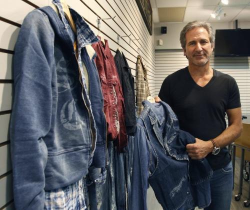 Michael Silver, CEO of Silver Jeans Co., with some  Silver Jeans clothing. The company, best known for wholesaling its Silver Jeans to department stores and other retailers, is preparing to open five stores in the U.S. in the next few months. Canadian stores are part of the two-to-three-year plan.Geoff Kirbyson story(WAYNE GLOWACKI/WINNIPEG FREE PRESS) Winnipeg Free Press April 25 2013