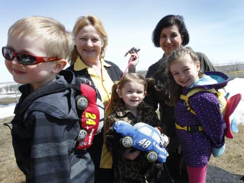 Finance.. In back at left is Heather Campbell-Dewar beside Nancy Vardalos Ginakes with friends' children (ltor) Bode Lynch, Ivy Cooper and Whitley Monforton  with  Safe2Go backpack/harness products.  story(WAYNE GLOWACKI/WINNIPEG FREE PRESS) Winnipeg Free Press April 26 2013