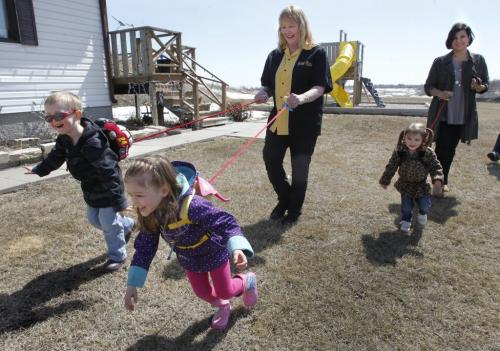 Finance.. At left in back is Heather Campbell-Dewar beside  Nancy Vardalos Ginakes with friends' children (ltor) Bode Lynch, Whitley Monforton and Ivy Cooper trying out the  Safe2Go backpack/harnesses.  story(WAYNE GLOWACKI/WINNIPEG FREE PRESS) Winnipeg Free Press April 26 2013