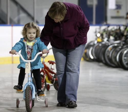 Allison Stubbe, 2, and her grandmother, Karen Philip looking for a new ride at the bike auction at Varsity View Community Centre, Saturday, April 27, 2013. (TREVOR HAGAN/WINNIPEG FREE PRESS)