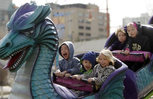 Bradlee Cheng, 8, Jaden Cheng, 4, and Piper Beaudry on a ride at the carnival near The Forks, Saturday, April 27, 2013. (TREVOR HAGAN/WINNIPEG FREE PRESS)