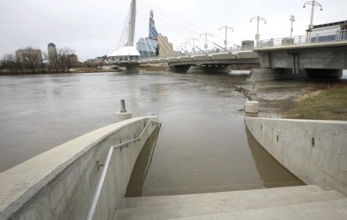 The rising Red River on the stairs that lead to the flooded walkway under the Esplanade Riel Pedestrian Bridge. story Wayne Glowacki/ Winnipeg Free Press April 29 2013¤