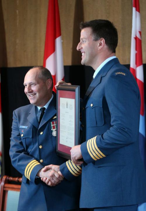 Former Winnipeg Blue Bomber football player Doug Brown, right, today became the Honorary Colonel  of the Canadian Forces School of Aerospace Studies at 17 Wing Winnipeg  He accepts certificate during presentation from Ltd-Col Bradley Baker-Standup Photo- April 30, 2012   (JOE BRYKSA / WINNIPEG FREE PRESS)