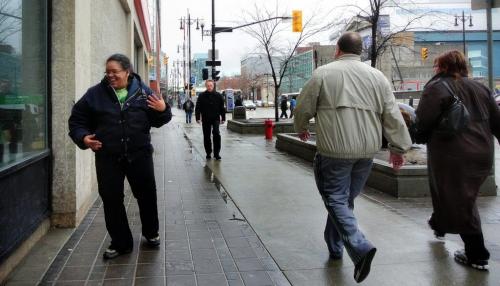 Belinda Bynum dances on the sidewalk while listening to her iPod on her break in Winnipeg's downtown Tuesday afternoon.  130430 April 30, 2013 Mike Deal / Winnipeg Free Press