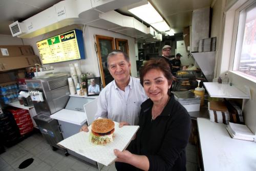 Mrs. Mike's  Hamburger Stand at  286 Tache Ave. has been operating fro 45 years. Owner(s): Cathy Mikos, and her brother in law Steve Mikos hold famous homemade burger inside  their quaint  kitchen.   This is for an Icons piece on popular St. Boniface hamburger stand; this is the first year the drive-in has opened without founder Nick Mikos (Cathy's husband) who died last summer. Shots of Cathy and her brother-in-law Steve, with one of Mrs. Mike's famous  King Burgers. Also an exterior shot of drive-in,    Photography Ruth Bonneville Ruth Bonneville /  Winnipeg Free Press)