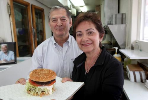 Mrs. Mike's  Hamburger Stand at  286 Tache Ave. has been operating fro 45 years. Owner(s): Cathy Mikos, and her brother in law Steve Mikos hold famous homemade burger inside  their quaint  kitchen.   This is for an Icons piece on popular St. Boniface hamburger stand; this is the first year the drive-in has opened without founder Nick Mikos (Cathy's husband) who died last summer. Shots of Cathy and her brother-in-law Steve, with one of Mrs. Mike's famous  King Burgers. Also an exterior shot of drive-in,    Photography Ruth Bonneville Ruth Bonneville /  Winnipeg Free Press)