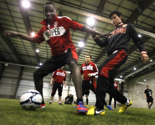 At left, WSA Winnipeg players Moses Danto plays keep away with Quentin Dreaver during the team's warmup in the Winnipeg Indoor Soccer Complex Wednesday prior to the news conference to announce the kick-off of the 2013 season. The WSA Winnipeg team's first game is in Des Moines on Sat. May 18 and their home opener is on Sat. May 25 at 7:00p.m. vs Thunder Bay in the Winnipeg Indoor Soccer Complex.   Wayne Glowacki/Winnipeg Free Press May 1 2013