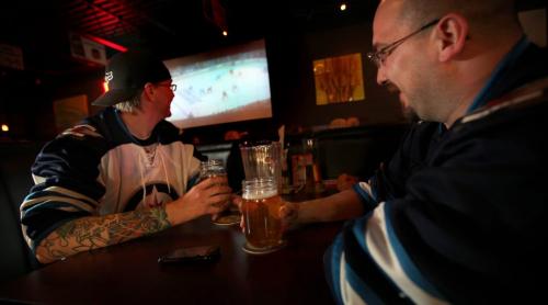 Steve Wilson (left) and buddy Dave Gowler share a microbrew at LuxaLune Wednesday evening watching a little hockey on the big screen. See story. May 1, 2013 - (Phil Hossack / Winnipeg Free Press)